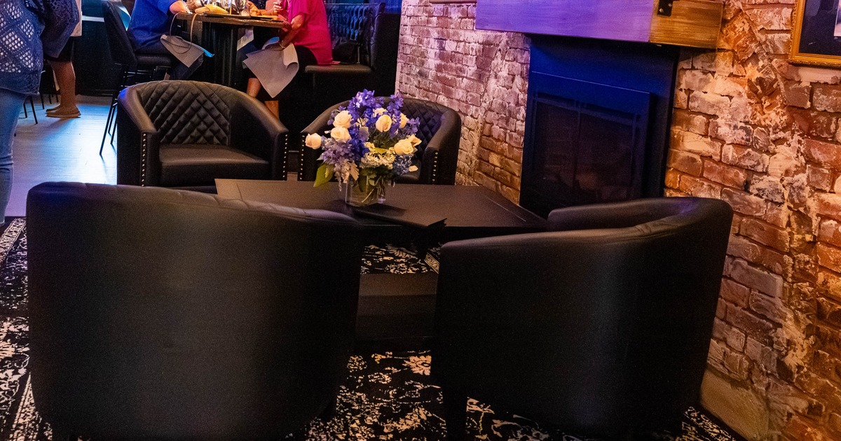 Cozy lounge area with black leather chairs