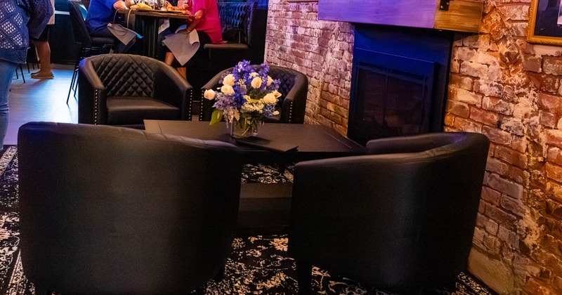 Cozy lounge area with black leather chairs