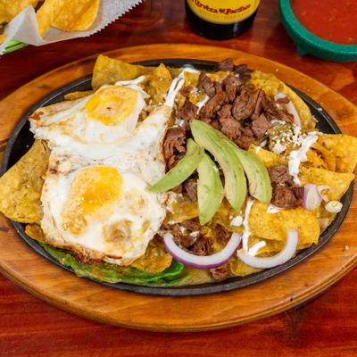 Chilaquiles meal with eggs and avocado.