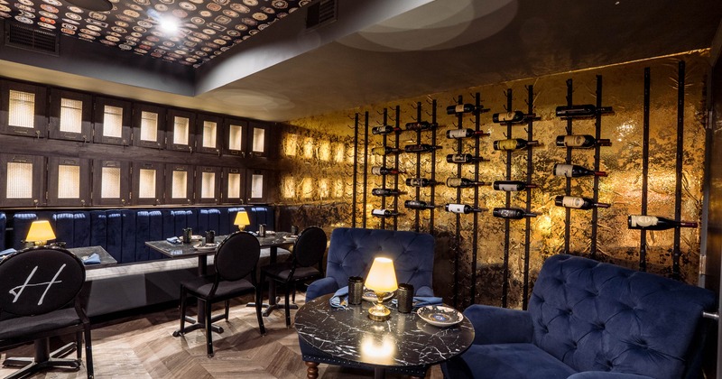 Interior of a luxurious dining space with dark wood and gold accents