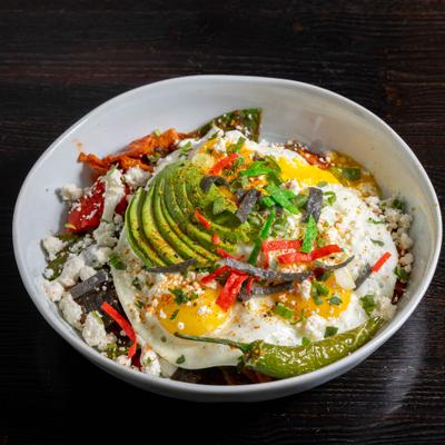 Huevos rancheros with avocado and roasted peppers.