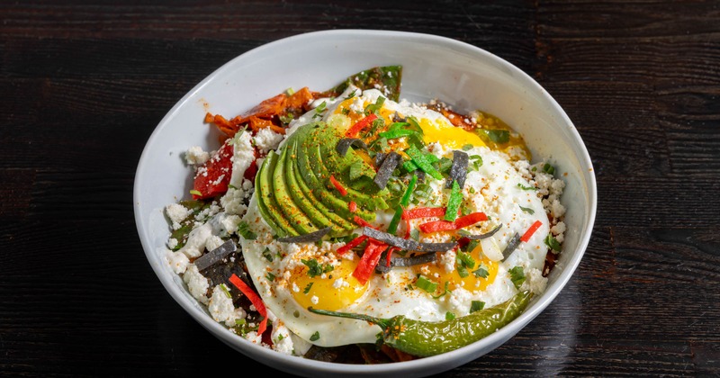 Egg bowl with avocado, peppers and crumbled cheese