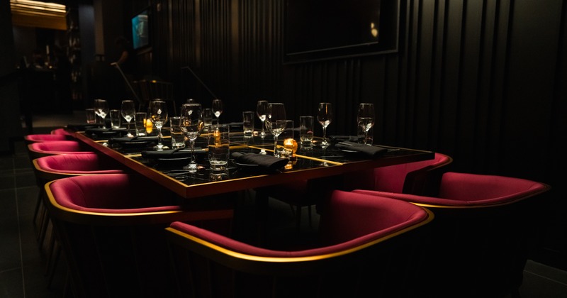 Private dining table set with glasses, side plates and napkins