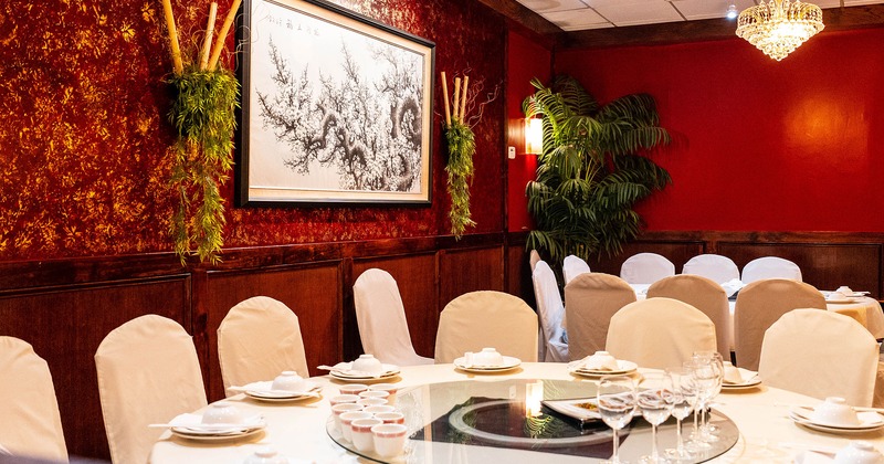 Chinese round dining table with tableware, glasses and accessories close up