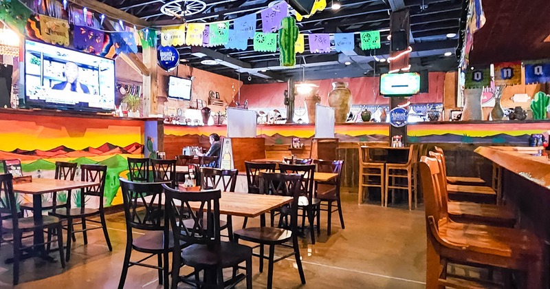 Interior, dining area with tables, chairs and Mexican decorations