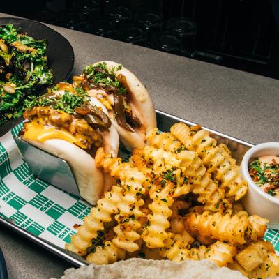 Stuffed buns served alongside seasoned  fries.