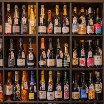 A great assortment of bottled wines on shelves.