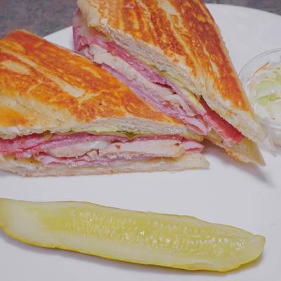 Cuban sandwich, with ham, roasted pork, Swiss cheese, mayonnaise, and mustard.
