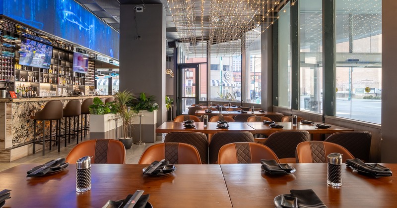Nicely done interior dining area with set tables and bar