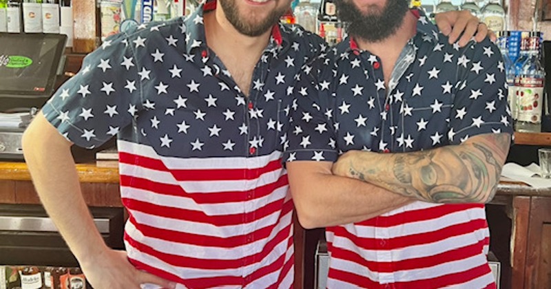 2 bartenders dressed in matching shirts for 4th of July.