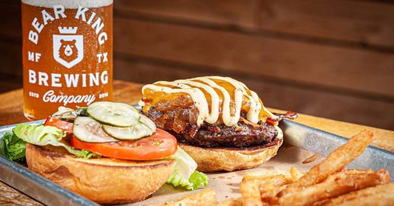 Cheeseburger served with beer