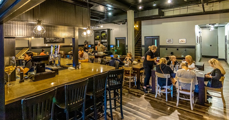 Interior, bar and dining area with guests