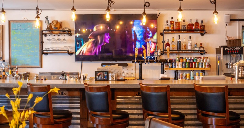 Bar, chairs, tv screen above