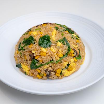 Fried rice with mushrooms, spinach, asparagus, corn, and scrambled eggs.