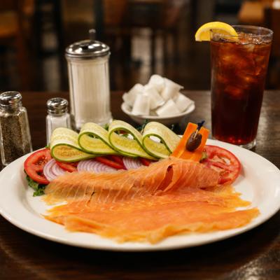 Mini Nova Platter served on the table alongside condiment and a glass of iced soda.