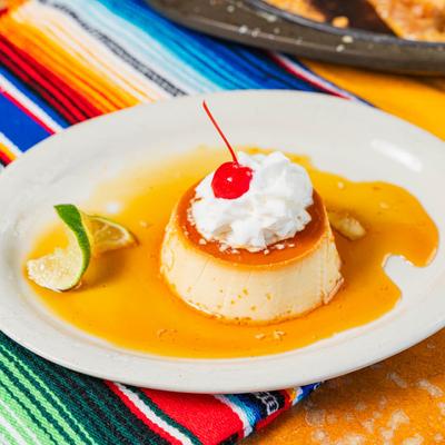 Flan, with whipped cream and cherry on top.