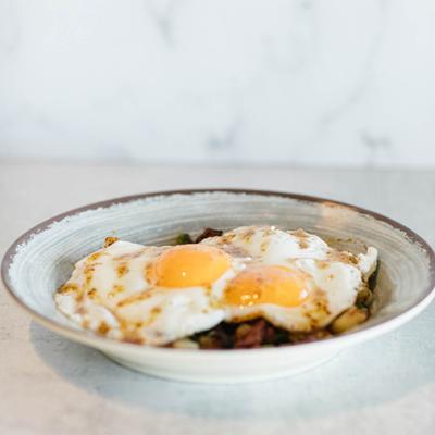 Corned beef and hash brown covered with two sunny side up eggs