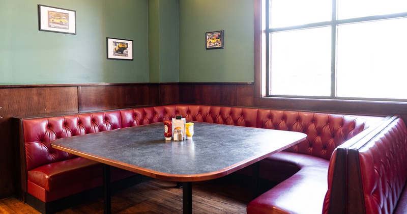 A large upholstered dining booth ready for guests