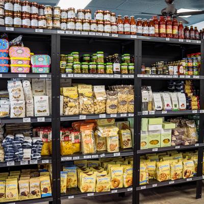 Store shelves stocked with assorted Italian products including pasta, sauces, and packaged cookies.
