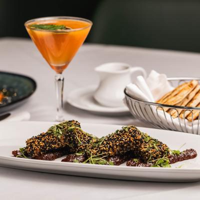 Feta crostata served with a cocktail and pita bread.