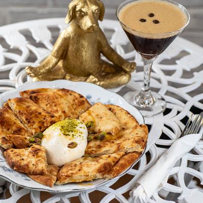 Truffle Burrata Grazing Board with espresso martini on the table.