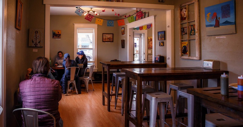 Interior, tables, chairs, lighting, decorations, people, windows