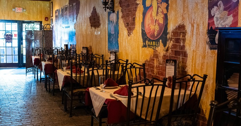 Dining area featuring table seating, exposed brick walls and textured yellow paint