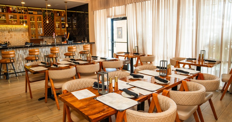 Interior, dining area, entrance, dining area, bar with stools in the back