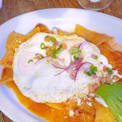Chilaquiles dish, with corn tortillas, poached egg, avocado, and pico de gallo.