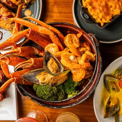 Cajun-style seafood served alongside other menu items.