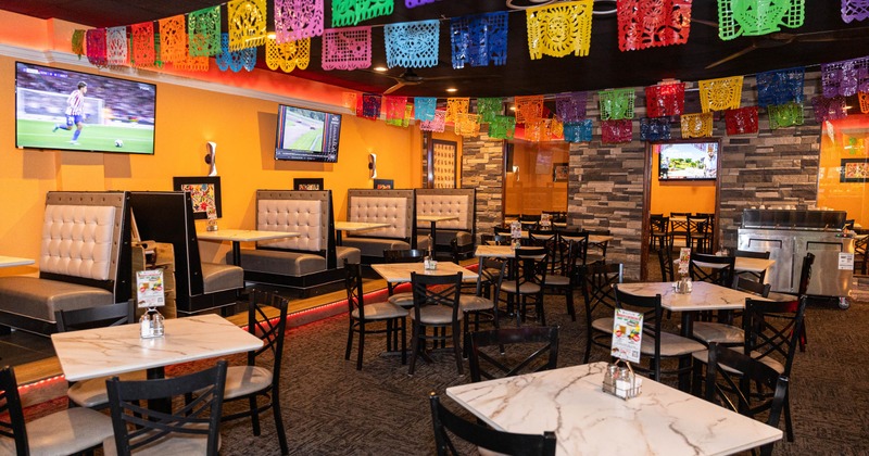 Interior of a restaurant, orange walls, booths