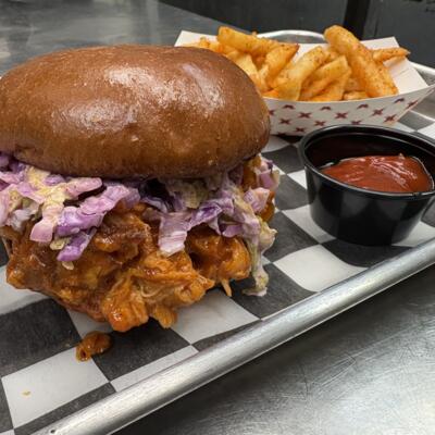 Pulled chicken sandwich with creamy slaw served with seasoned fries and ketchup.