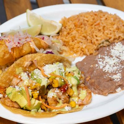 Fish and Shrimp tacos, served with rice, and refried beans.