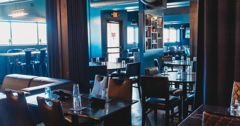 Interior, dining area, wooden top tables with chairs, ready for guests, curtains as dividers