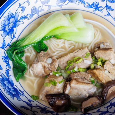 Noodle soup with ribs, bok choy, mushrooms, and scallions.