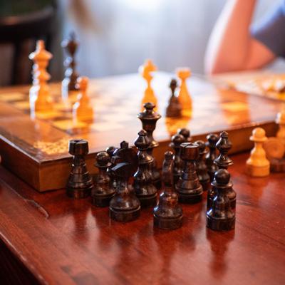 Chess pieces arranged on a wooden table.