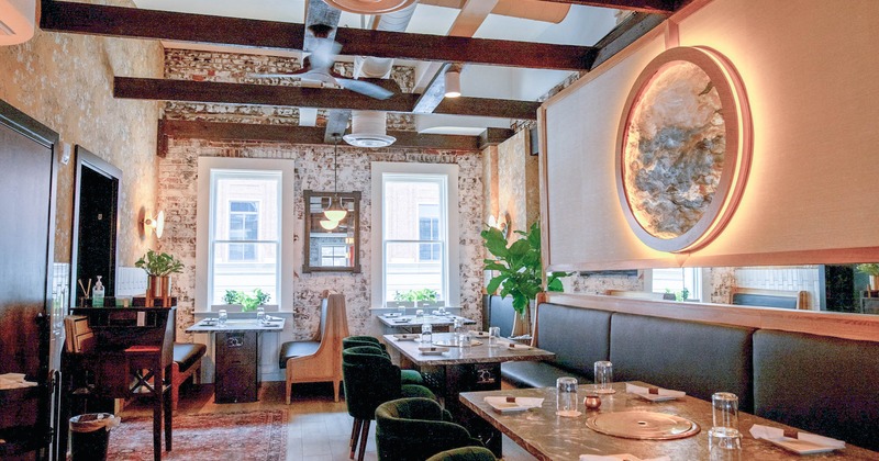 Interior, set tables, benches, brick walls, windows, lighting, plants