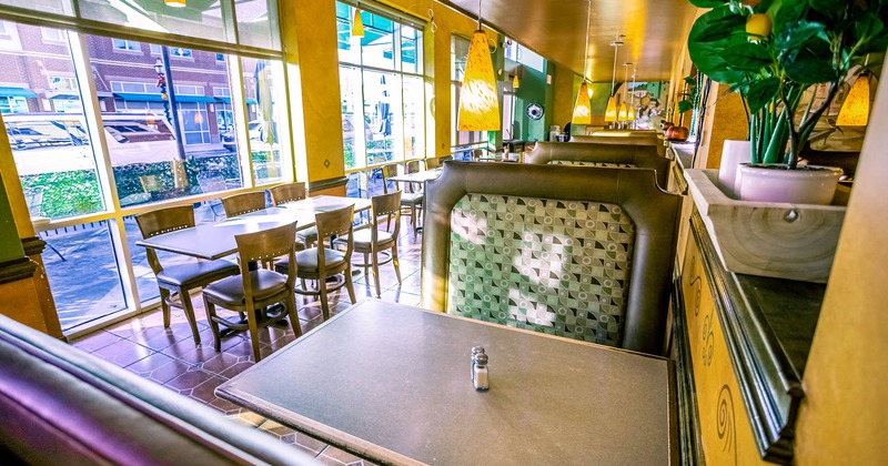 Booth inside, dining tables with chairs