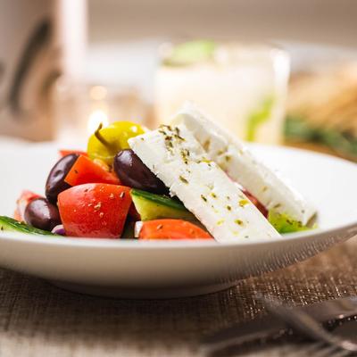 Horiatiki Salad, with tomatoes, red onion, peppers, olives, and feta.