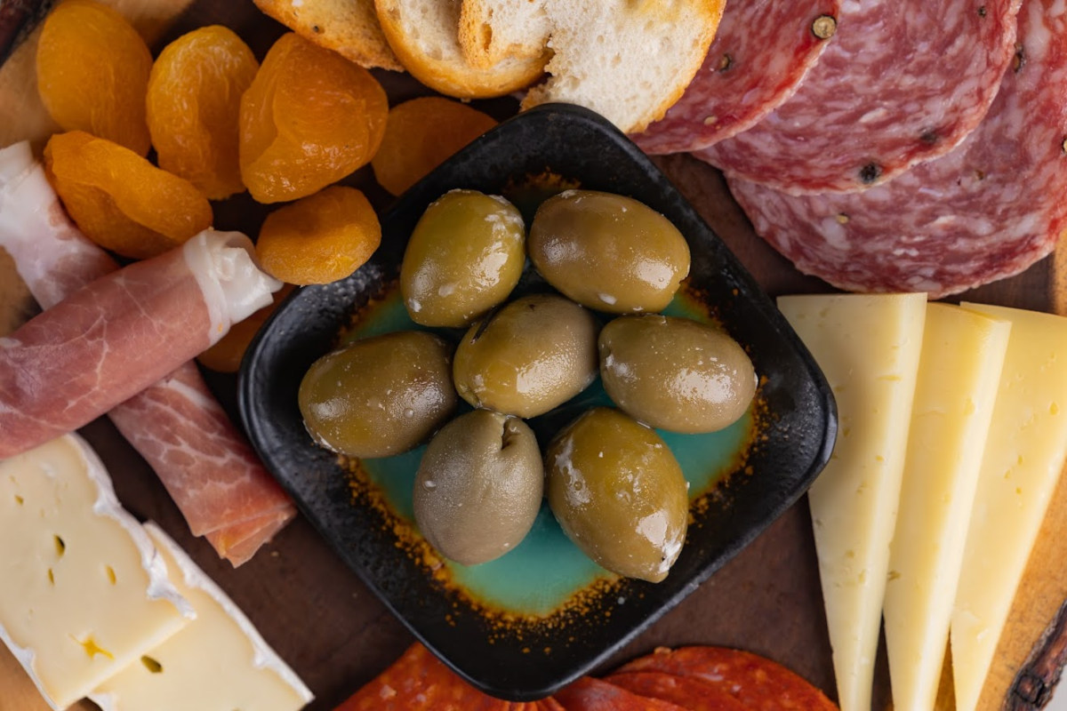 Prosciutto, cheese, olives, dried apricots, top view