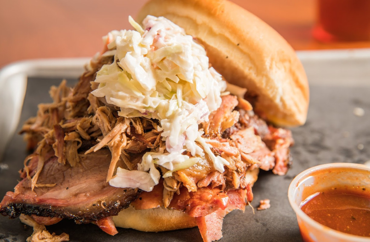 Pulled Pork and Sausage Piled High Topped with Slaw and Sauce
