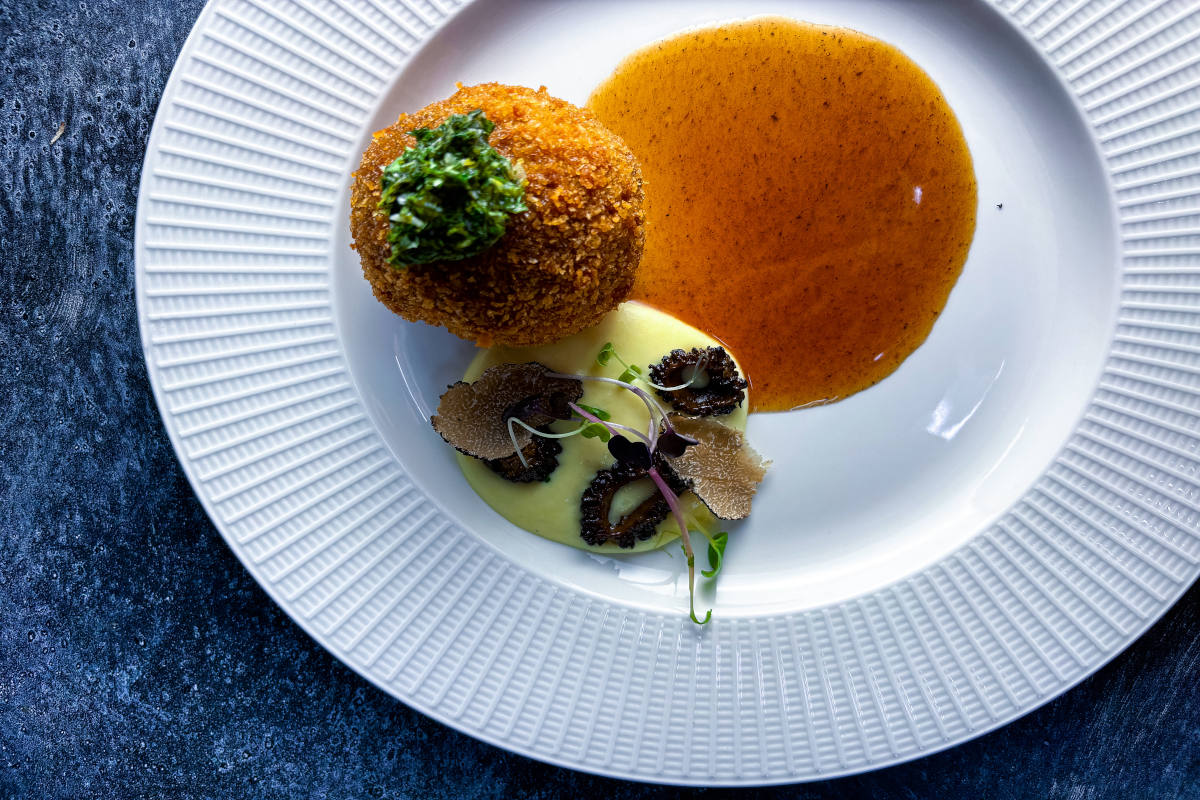 A white plate elegantly presenting a colorful dish of food