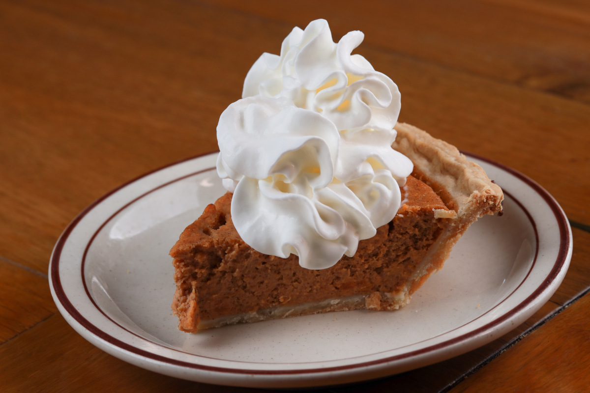 A slice of pie dessert with cream