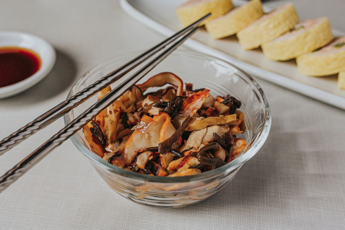 Squid tossed with bamboo shoots, carrots, Japanese tree mushrooms, and sesame seeds