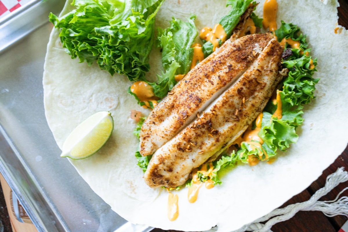 Grilled seasoned fish filet with lettuce