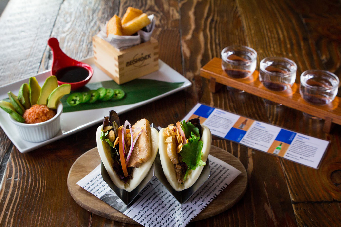 photo of fish burgers with avocado salad and sake