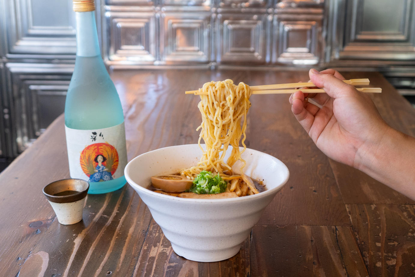 a bowl filled with steaming noodles and sake