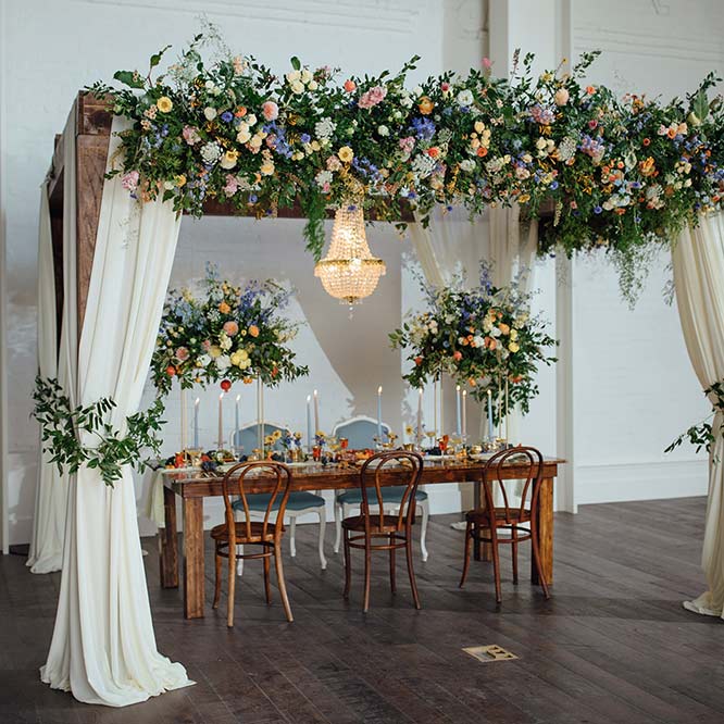 Table decorated with flowers for bride and groom