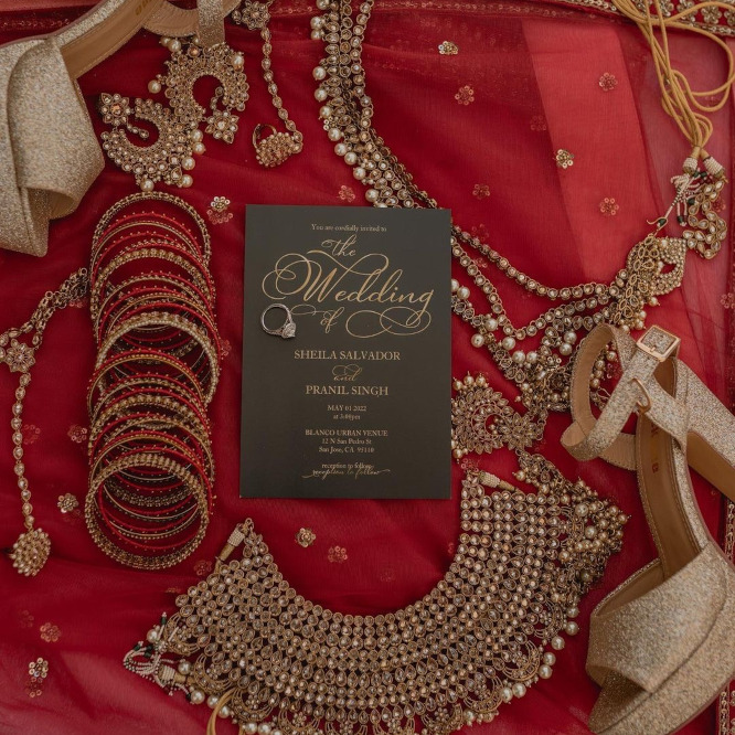 Wedding invitation with jewelry scattered next to it