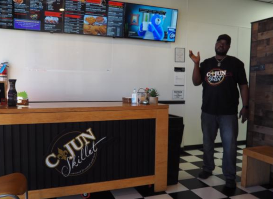 Indoor, owner with Cajun logo table
